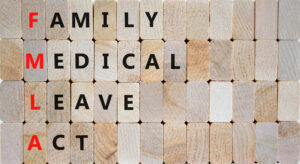 FMLA family medical leave act symbol. Concept words FMLA family medical leave act on wooden blocks on beautiful wooden background. Medical FMLA family medical leave act concept.