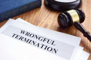 Wrongful termination. Documents and gavel on a desk.