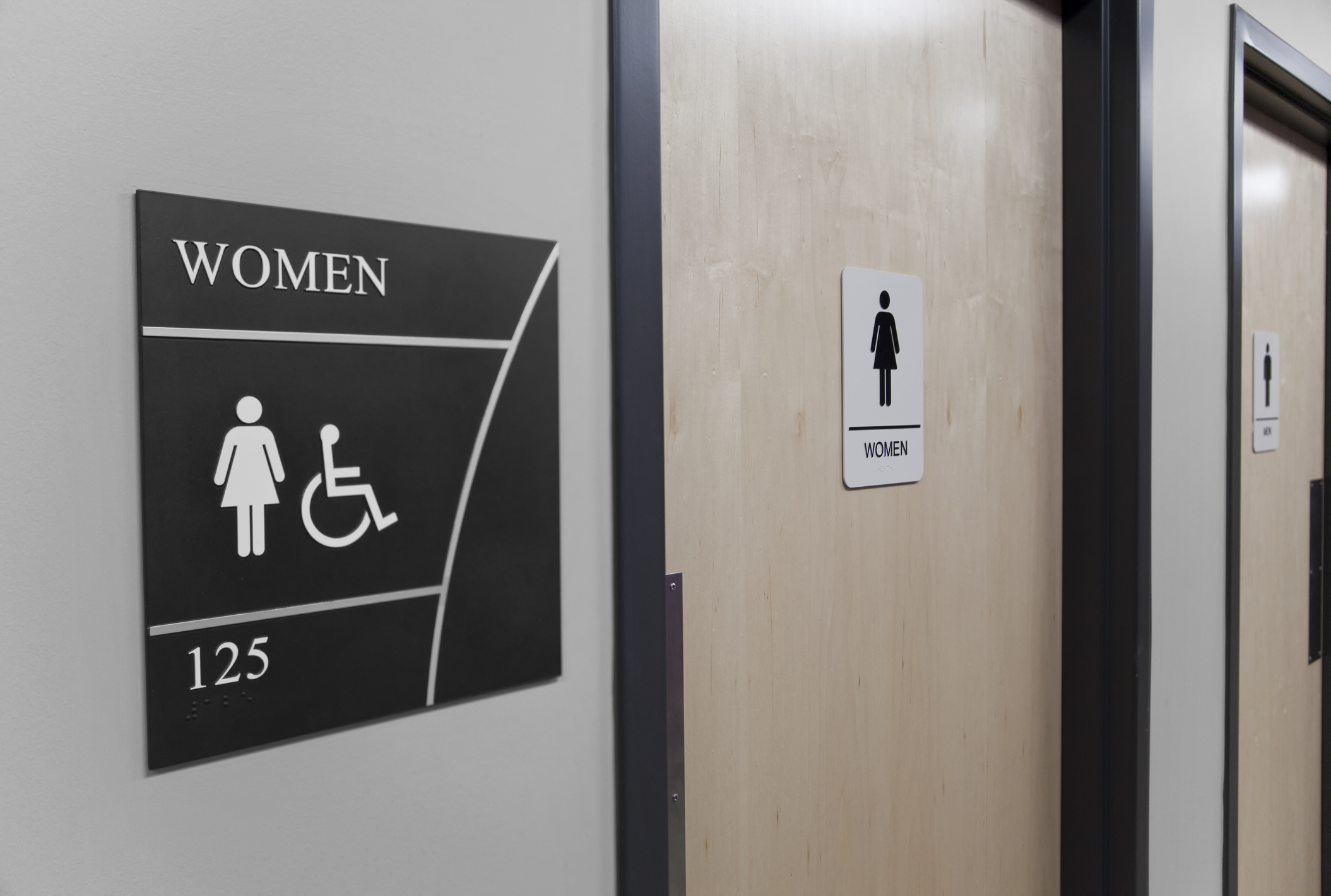 A woman's restroom sign beside the door